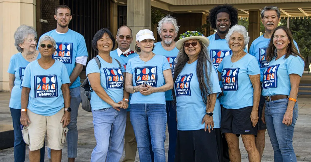 The Indivisible Honolulu crew wearing blue shirts with Indivisible logo
